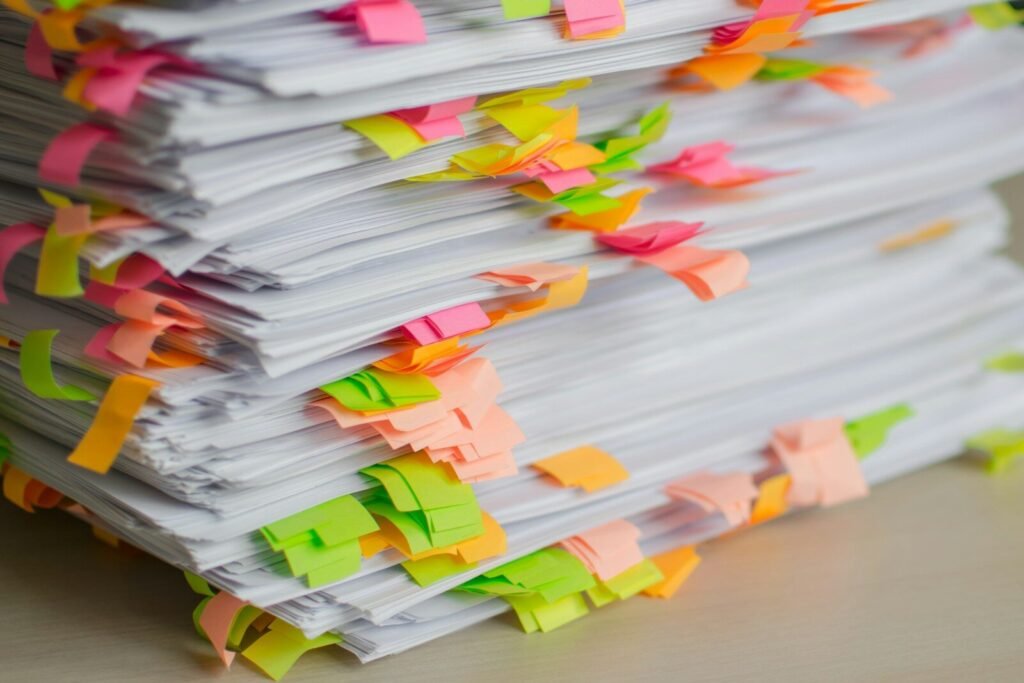 Stack of documents with colorful sticky note tabs, illustrating AI-powered document summarization